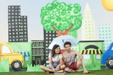 couple holding umbrella sitting in garden