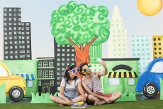 couple in garden taking selfie with mobile phone