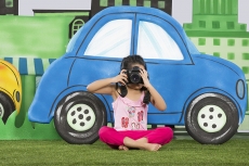 young girl clicking a photograph from camera in the park