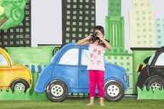  young girl clicking a photograph from camera in the park