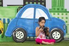 young girl clicking a photograph from camera in the park