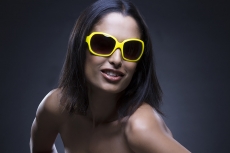 Young girl posing with sunglasses