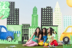Three girls sitting and posing 