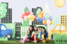 Three girls holding balloons