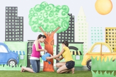 Two girls watering a tree