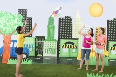 Three girls playing with kite in the park