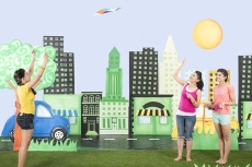 Three girls playing with kite in the park