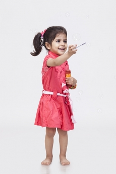 Little girl playing with bubble toy