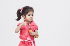 Little girl playing with bubble toy