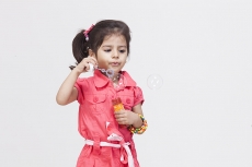 Little girl playing with bubble toy