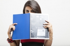 college girl posing while holding a text book
